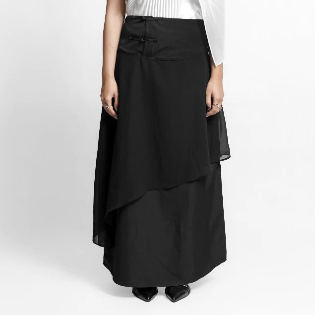 Black layered skirt by Isoos Studios worn by a person on a white background