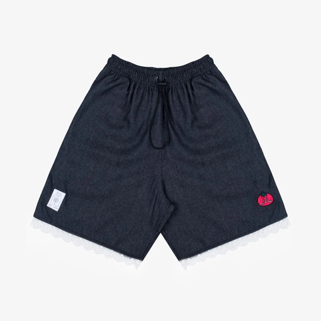 Dark blue denim shorts by Tome Ame with a small red and white label on a light gray background