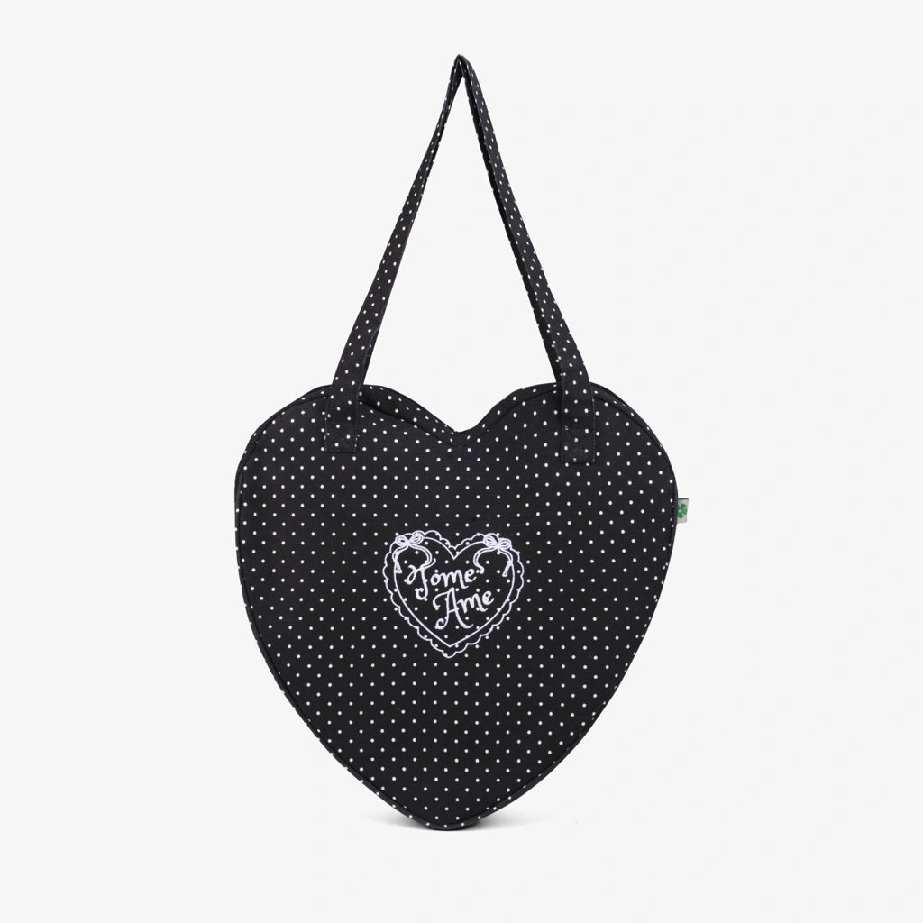 Heart-shaped bag from Tome Ame with black polka dot pattern on a white background