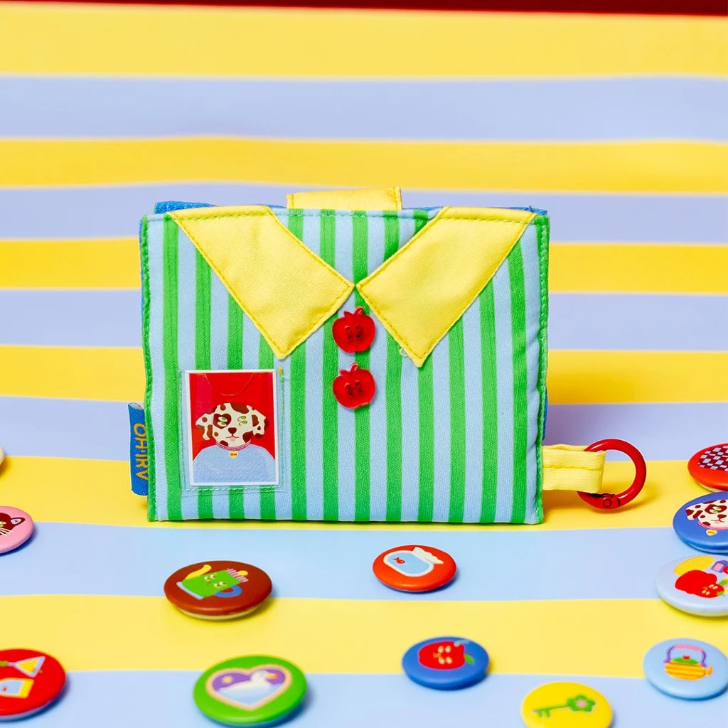 Colorful wallet by Oh.Irv with fabric buttons on a striped background