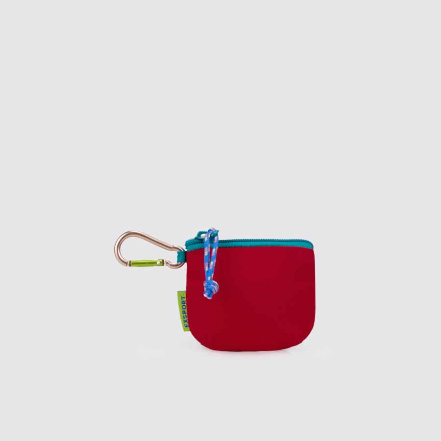 An Export Bags red coin pouch with a blue zipper and a carabiner attached to it.