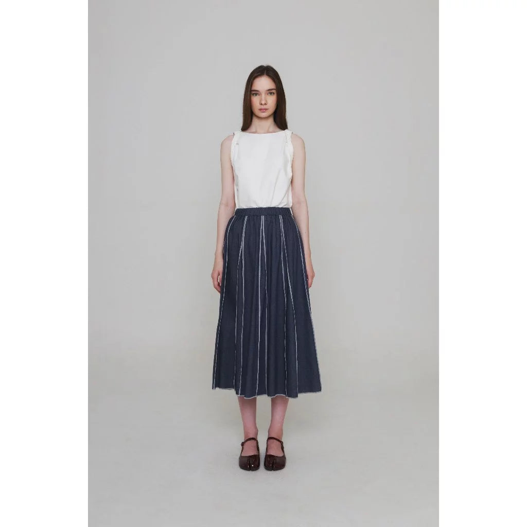 Woman wearing a white top and dark blue skirt by Morningsol on a plain background