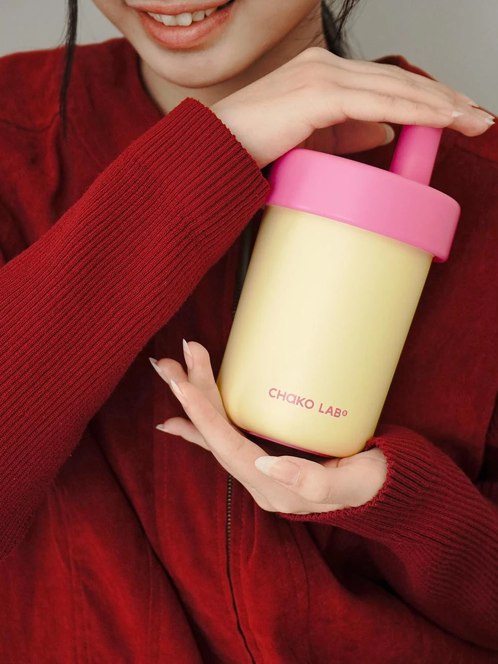 Person holding a broken white and pink Chako Lab vacuum cup.
