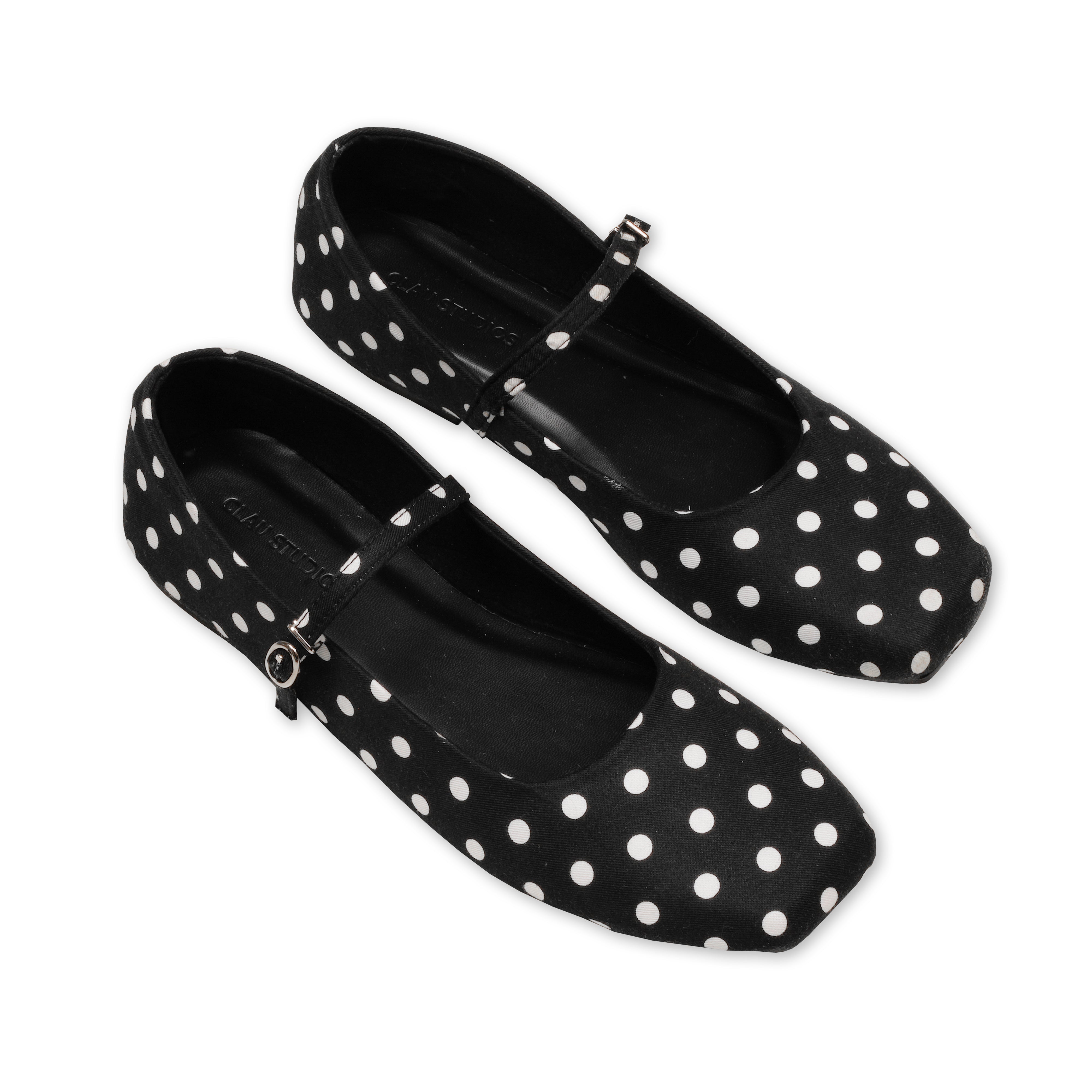 Black flatshoes with white polka dot on a white background