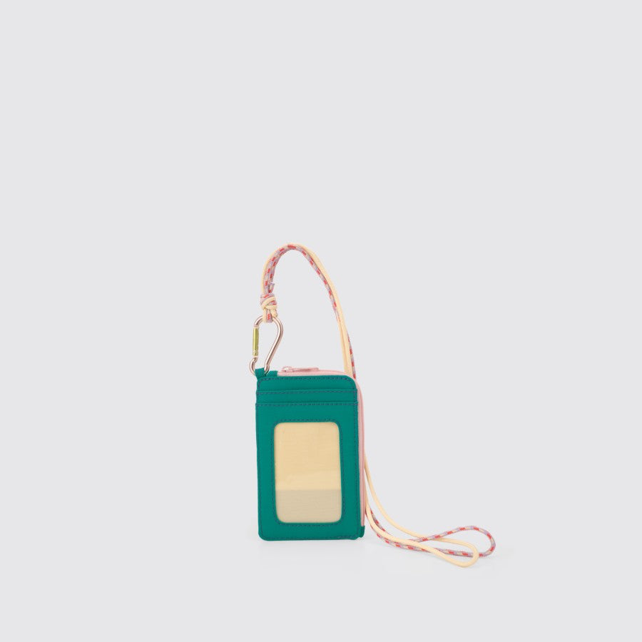 A green nylon lanyard card holder with a pink strap and a clear front card slot, featuring a carabiner and a 43 cm long neck strap from Exsport Bags.