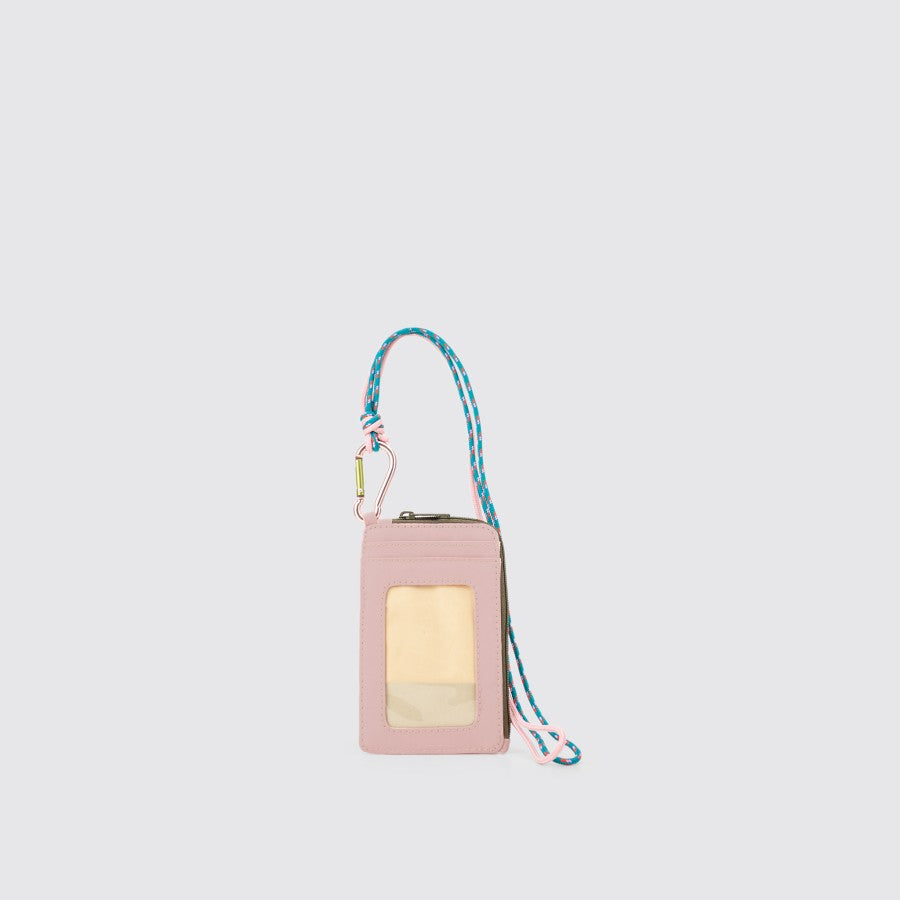 A light pink nylon lanyard card holder with a pink and light blue strap and a clear front card slot, featuring a carabiner and a 43 cm long neck strap from Exsport Bags.