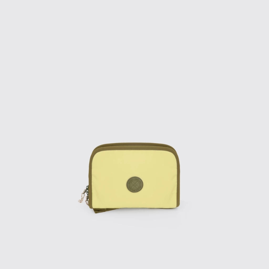 Light yellow Export Bags Everyday Multipurpose Pouch with green zipper on a light gray background