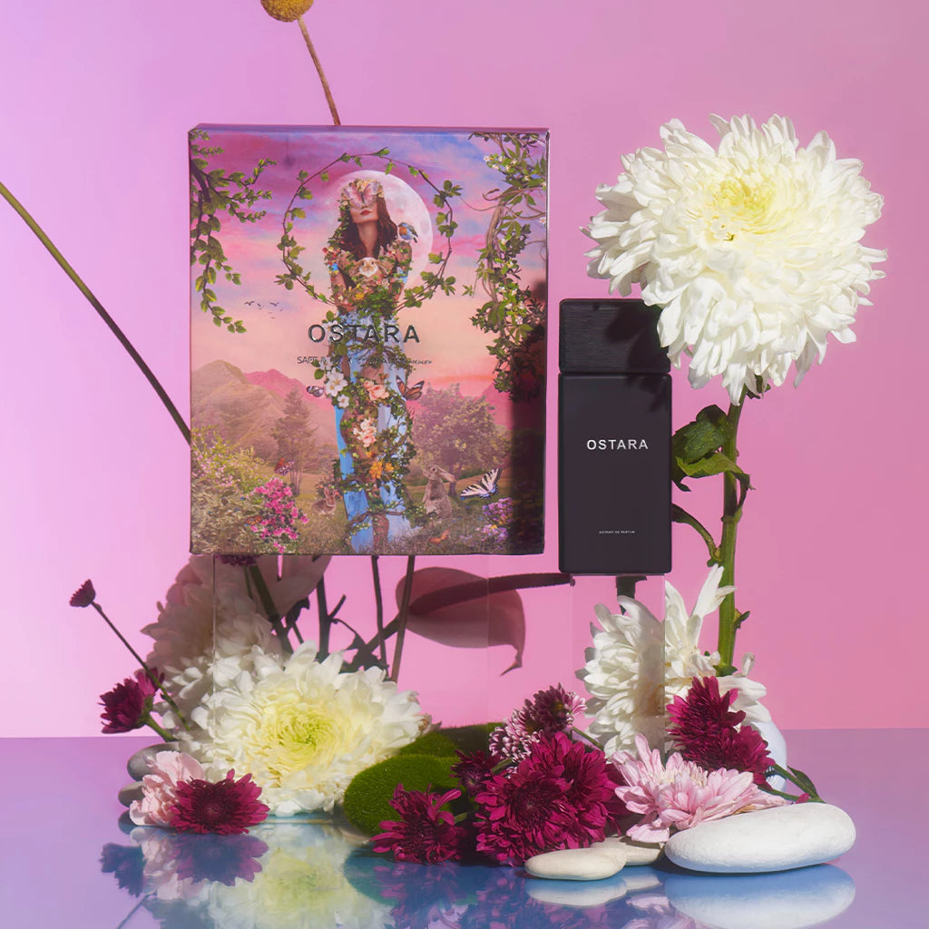Ostara perfume by Saff & Co with packaging and flowers on a pink background