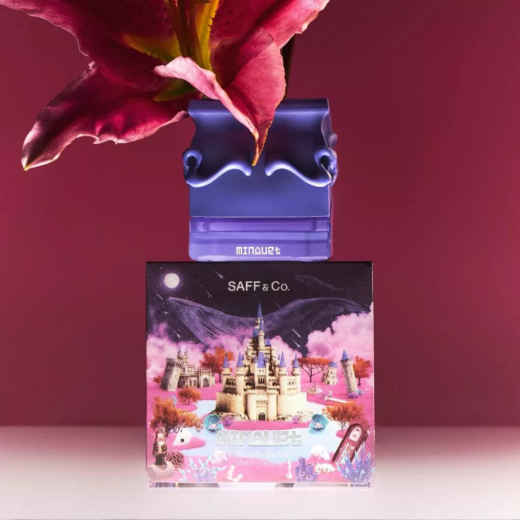 Minouet perfume bottle by Saff & Co with a pink flower against a red background, featuring a decorative packaging box with a castle design.
