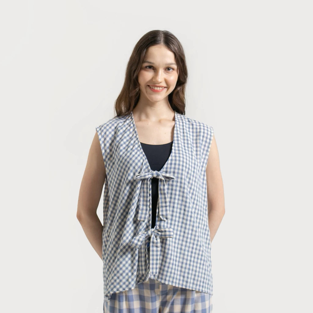 Woman wearing a blue white checkered Froyo Vest