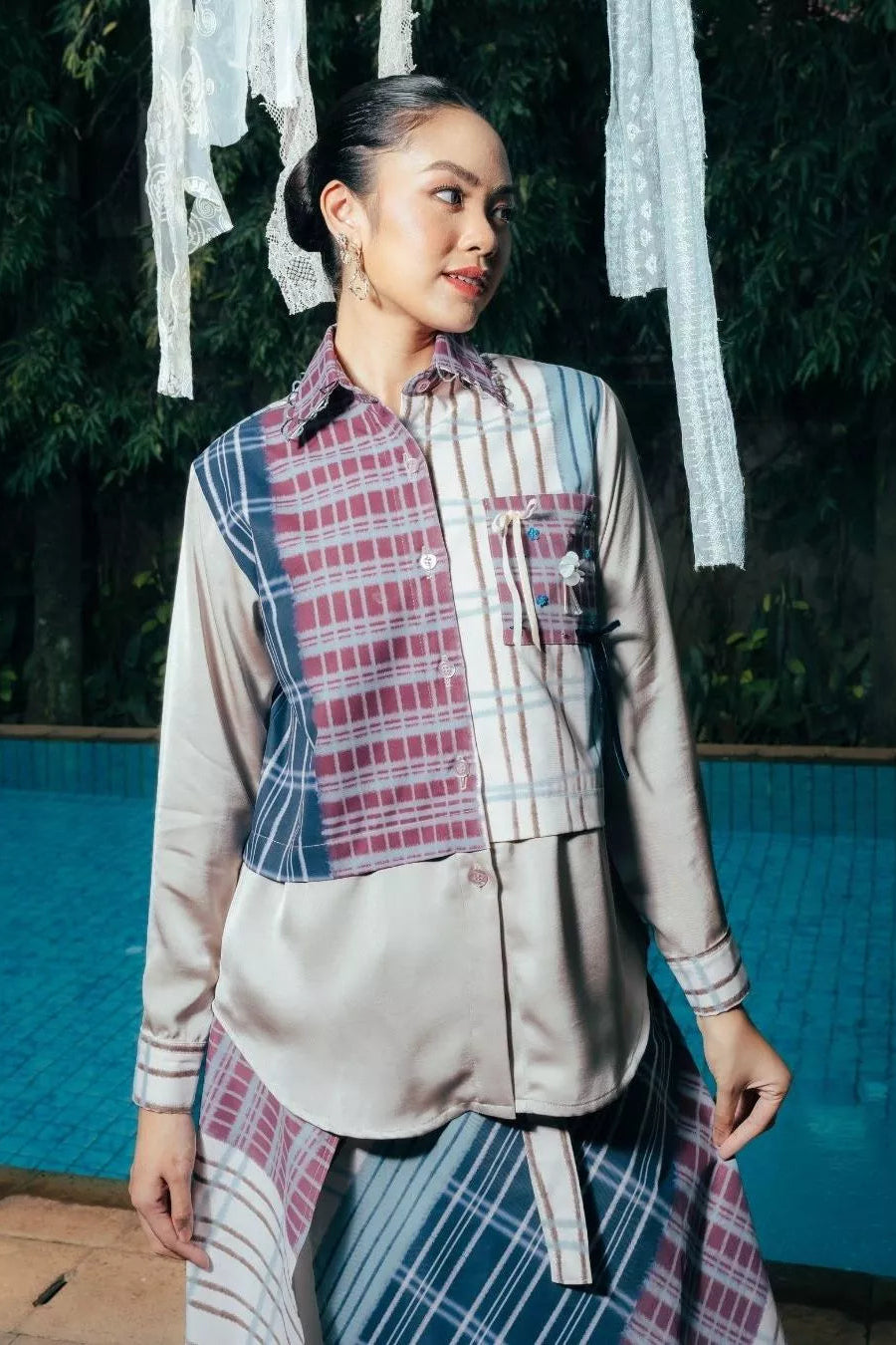 Woman wearing a plaid shirt by LR Studio and skirt with a neutral background