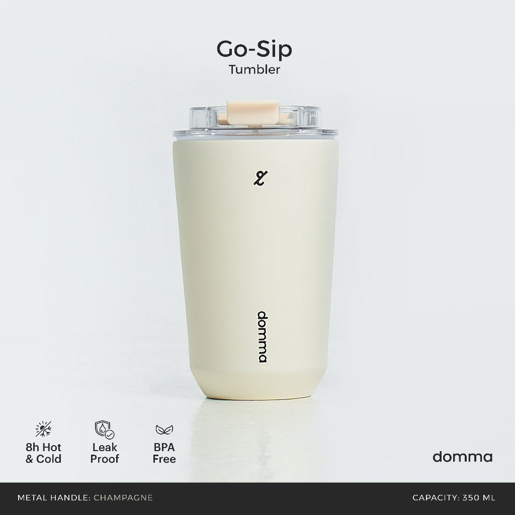 A cream stainless steel insulated travel mug with a Domma brand logo on the front.