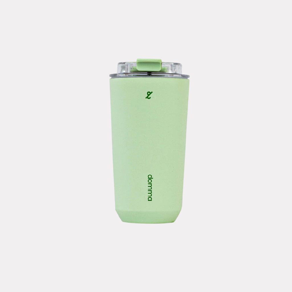 A green stainless steel insulated travel mug with a Domma brand logo on the front.