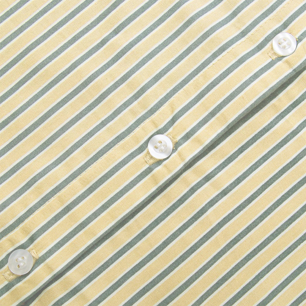 Close-up of a striped shirt with buttons by notyourcompany on a yellow and gray background