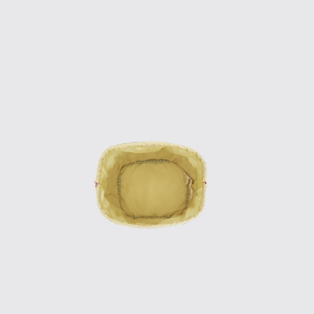 Top view of a Exsport lunch bag with a yellow woven inner on a light gray background