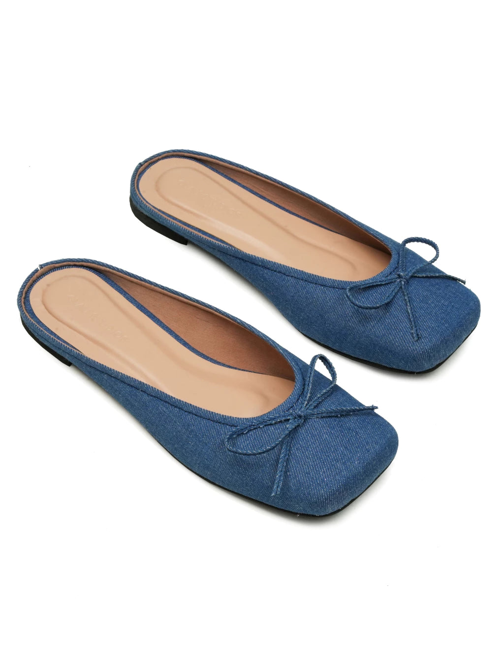 A pair of blue denim flat shoes with a synthetic leather insole and a non-slip sole, with a bow details at the front.