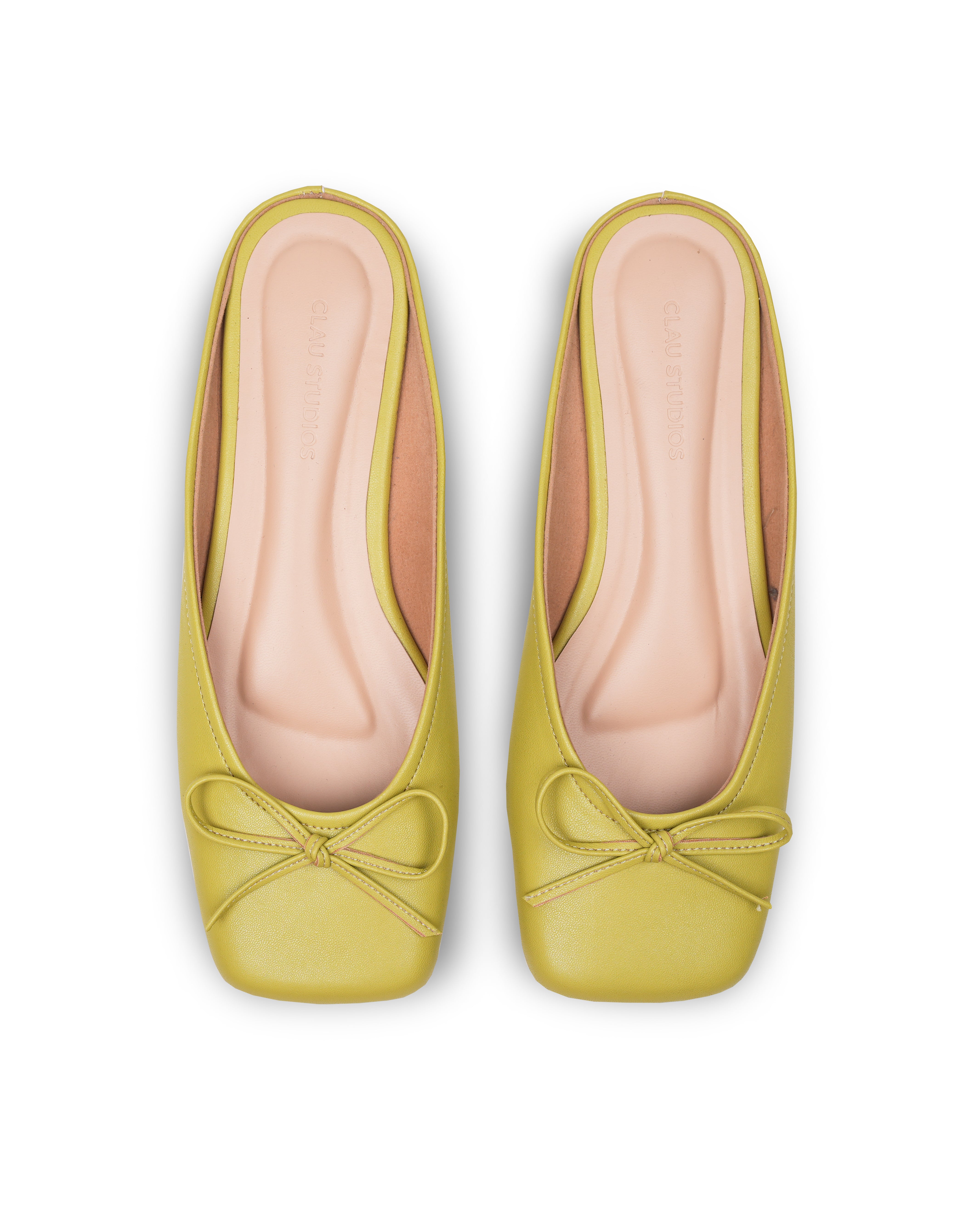 Pair of light green flat shoes with a bow details on a white background
