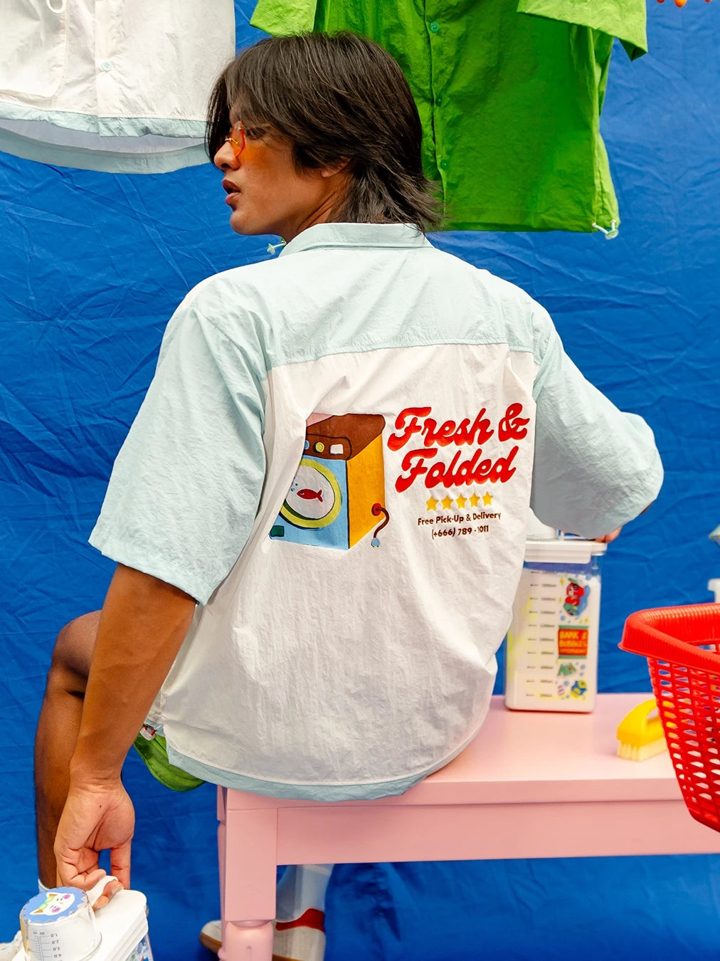 Person wearing a workshirt by Oh.Irv with 'Fresh & Folded' design at the back.