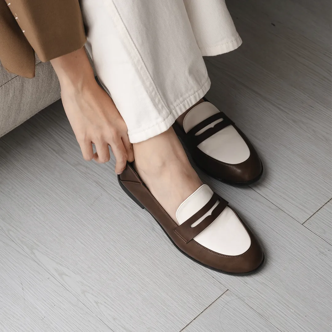 Women’s two-tone brown and white flat shoes in elegant loafer style, made from premium vintage faux leather, perfect for both formal and casual looks.