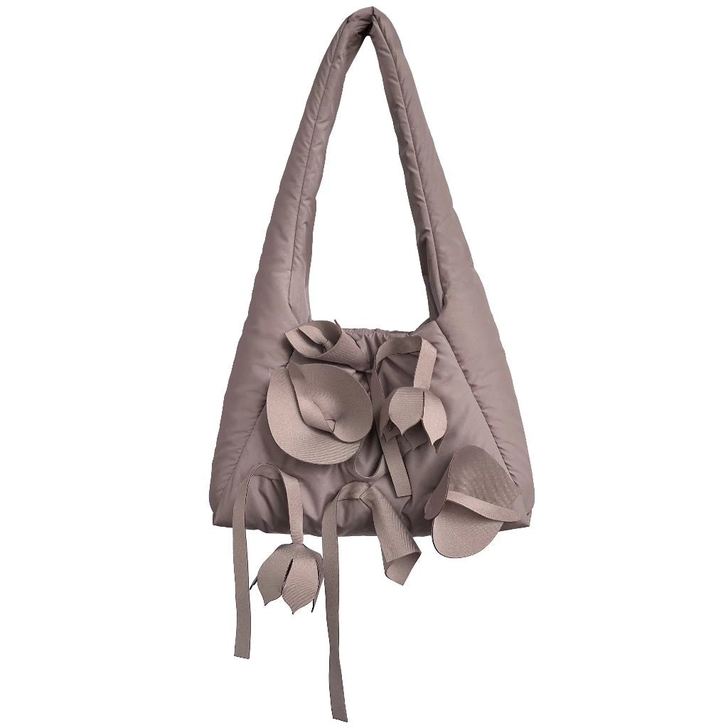 Light brown tote bag by Hunting Fields with floral attachments on a white background