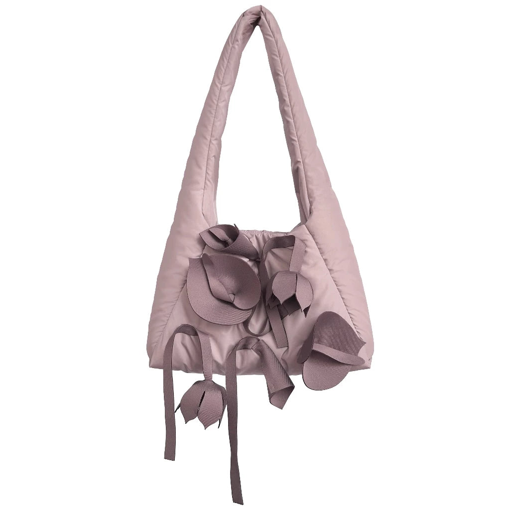 A light pink tote bag by Hunting Fields with a unique floral detail on the front and a smooth solid texture.