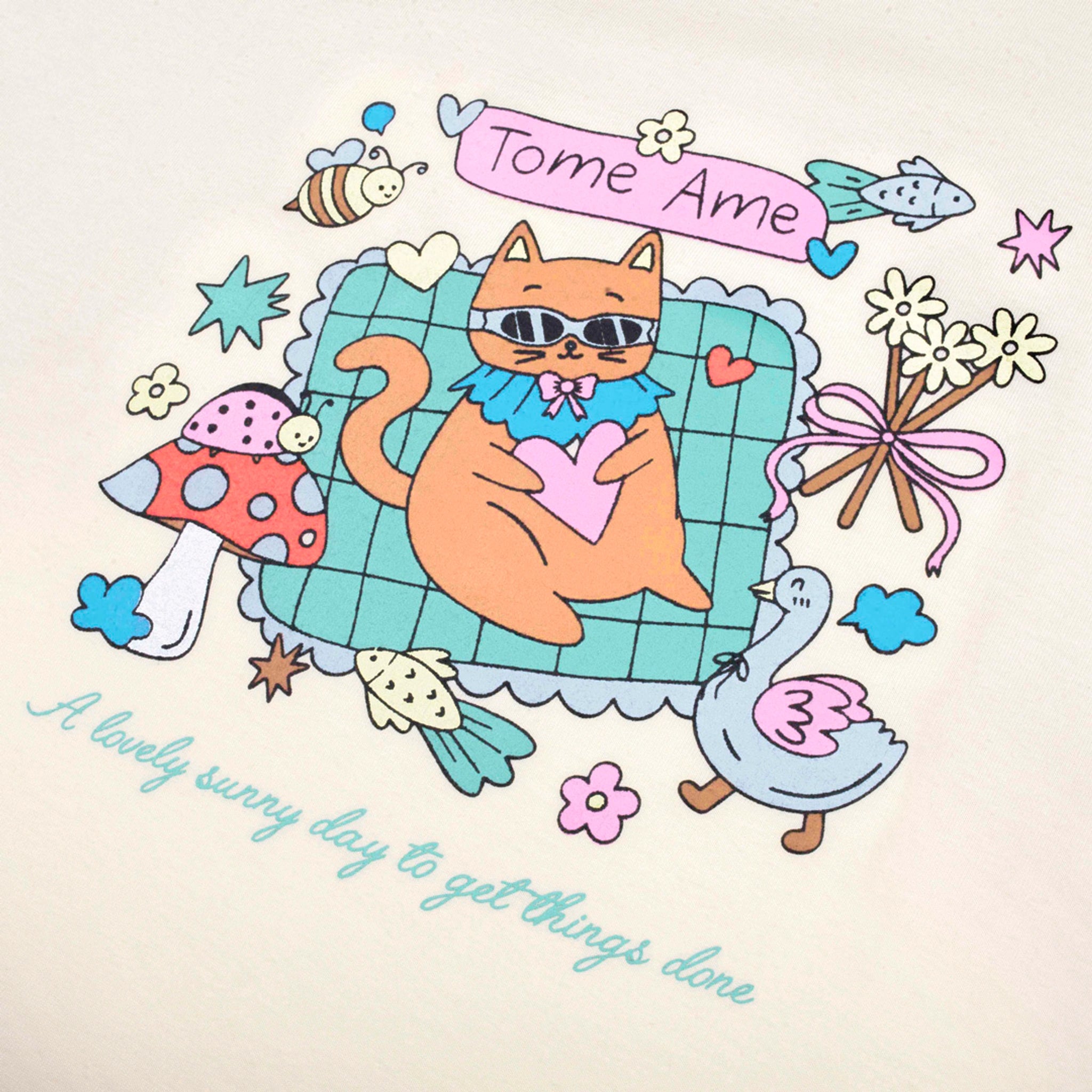 Cartoon cat lounging on a couch with decorative elements and text on beige t-shirt