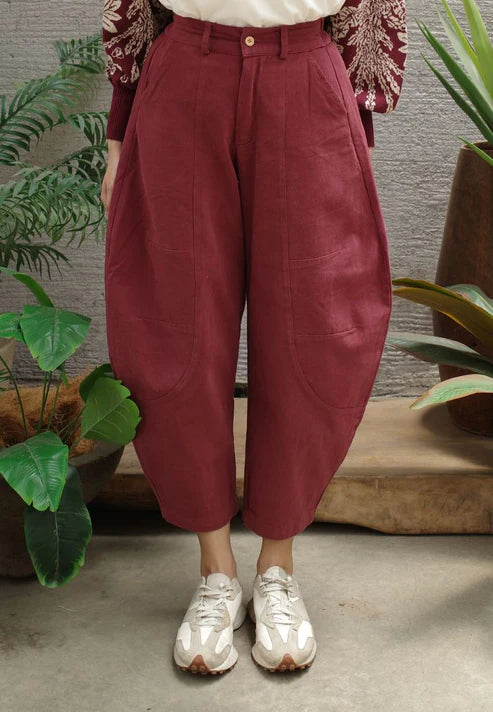 Maroon barrel pants worn by a person with a neutral background