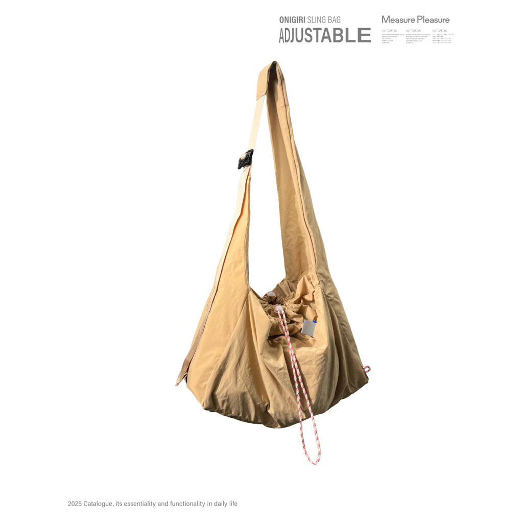 Yellow crossbody bag by Measure Pleasure with adjustable strap on a white background