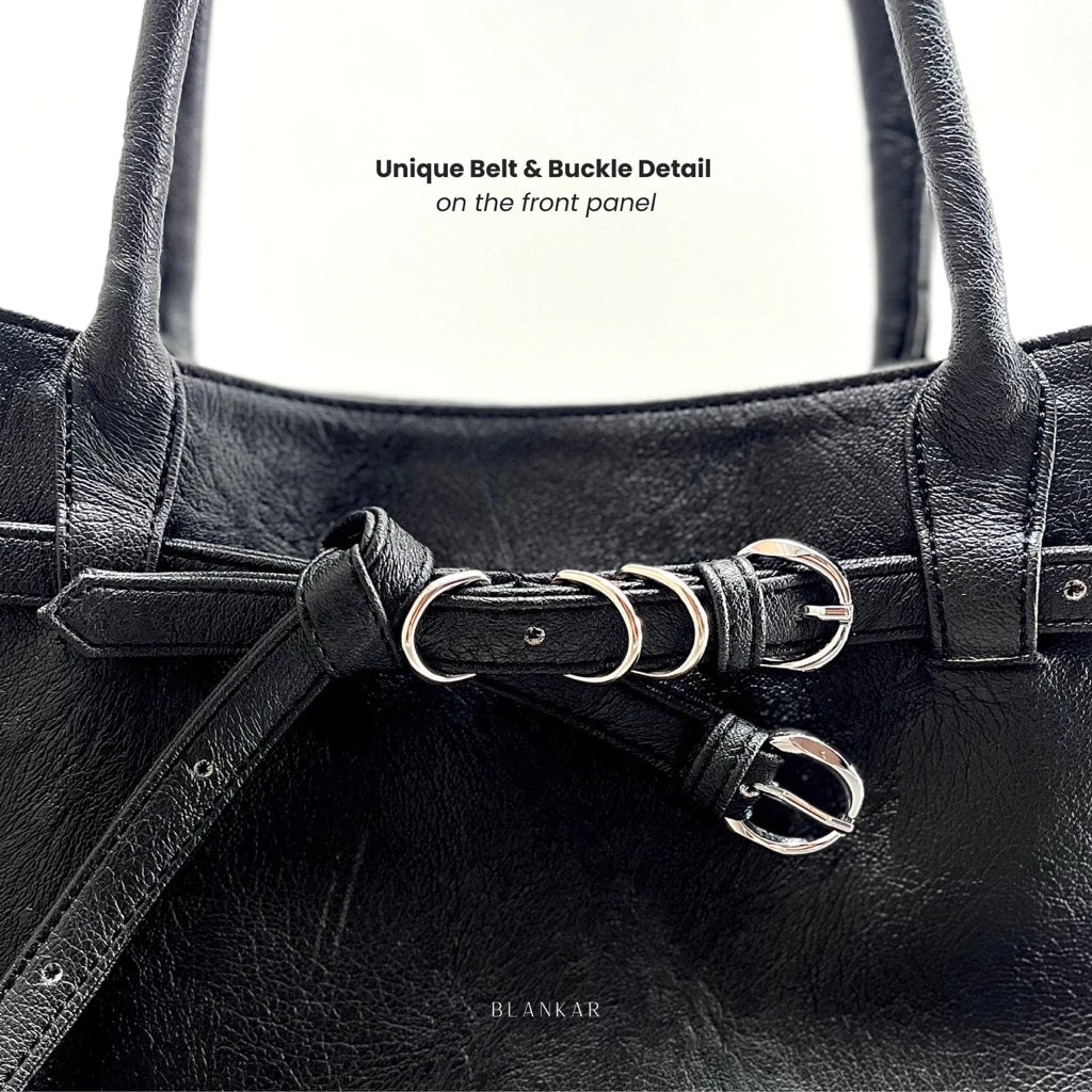 Black leather women's handbag with unique belt and buckle detail on a white background
Tas wanita berbahan kulit hitam dengan detail sabuk dan gesper yang unik pada latar belakang putih
