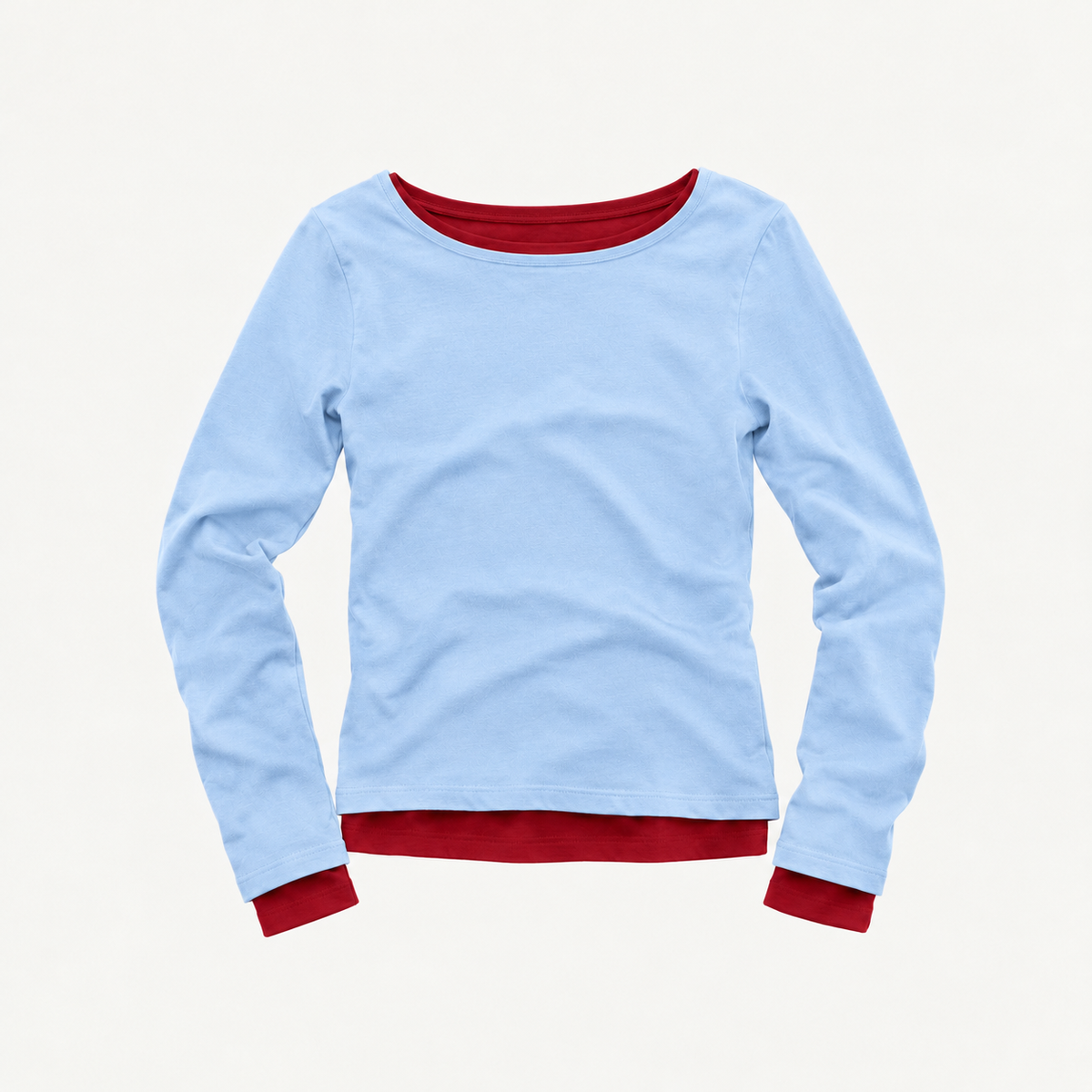 A light blue long-sleeve top by Tuff Puff with contrasting dark red trim at the collar, hem, and cuffs, displayed flat against a light cream background.
