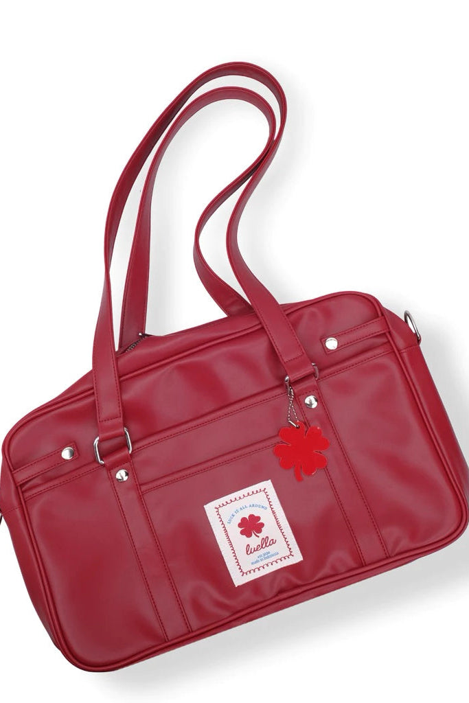 Red tote bag by Luella with a visible brand label on a white background