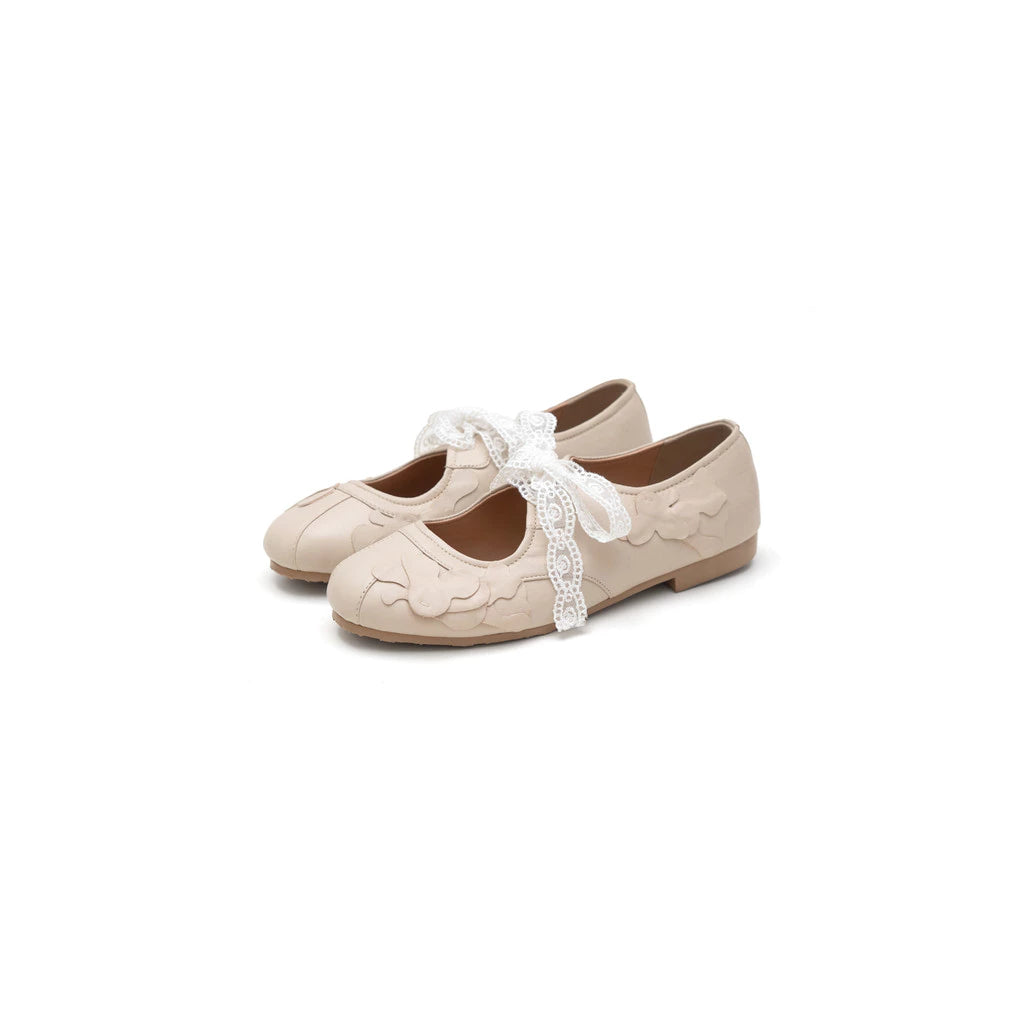 Pair of beige flatshoes with lace details by Cajsa on a white background