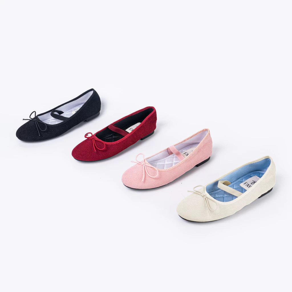 Four of colorful flatshoes with bow accents on a white background