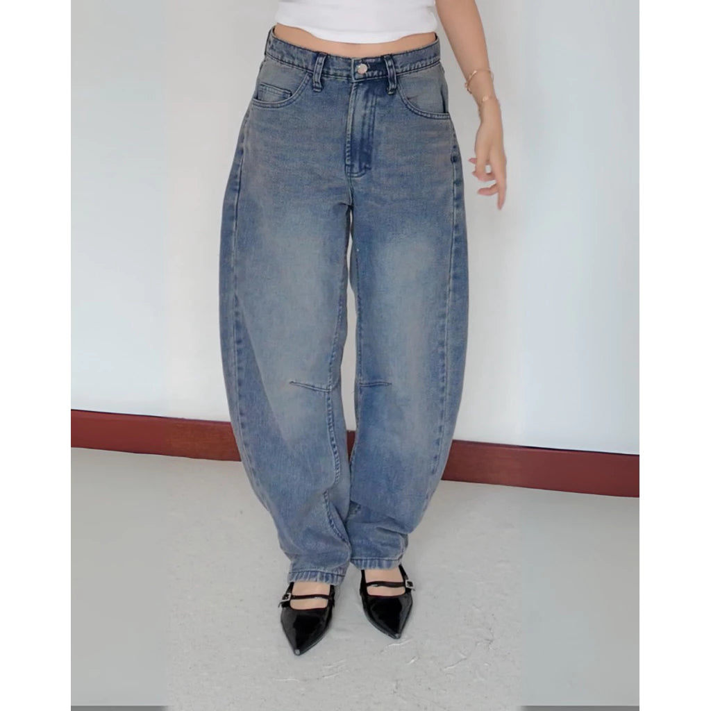 A closer look of Sora Barrel Denim Pants, a denim barrel pants from The Auctus, worn by a person on a plain background