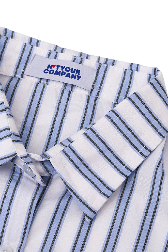 Close-up of a striped shirt with a 'Not Your Company' label on a white background