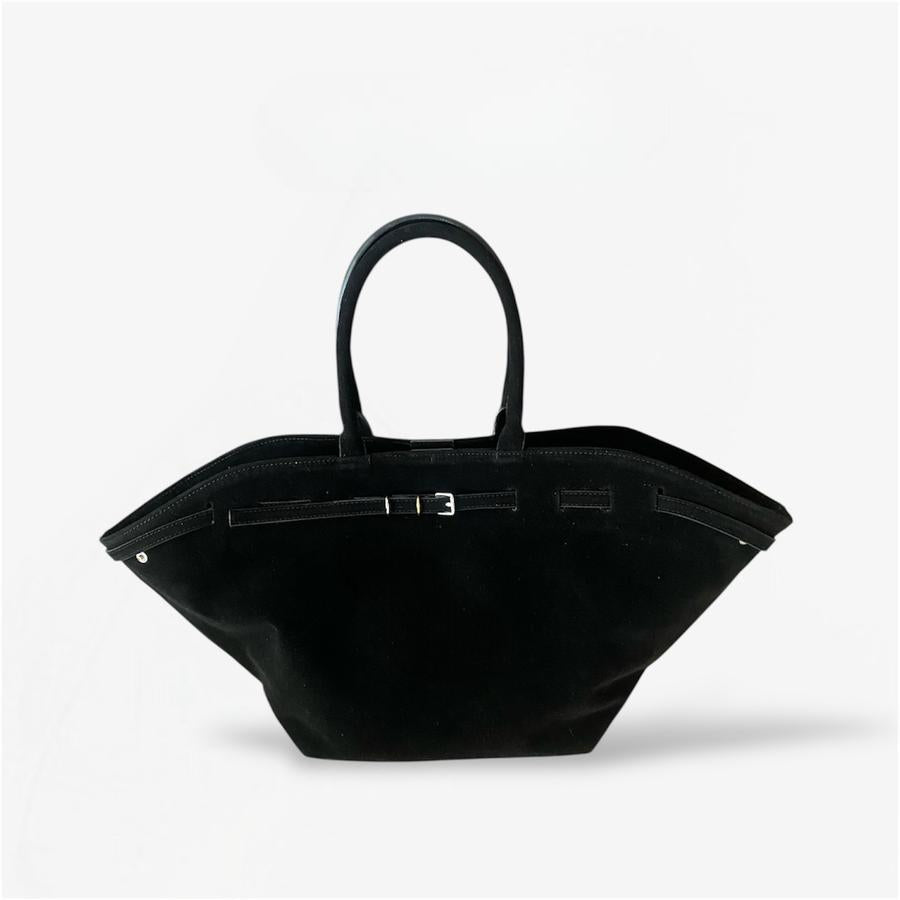 A black suede shoulder bag with a simple design and two handles from Masagi.