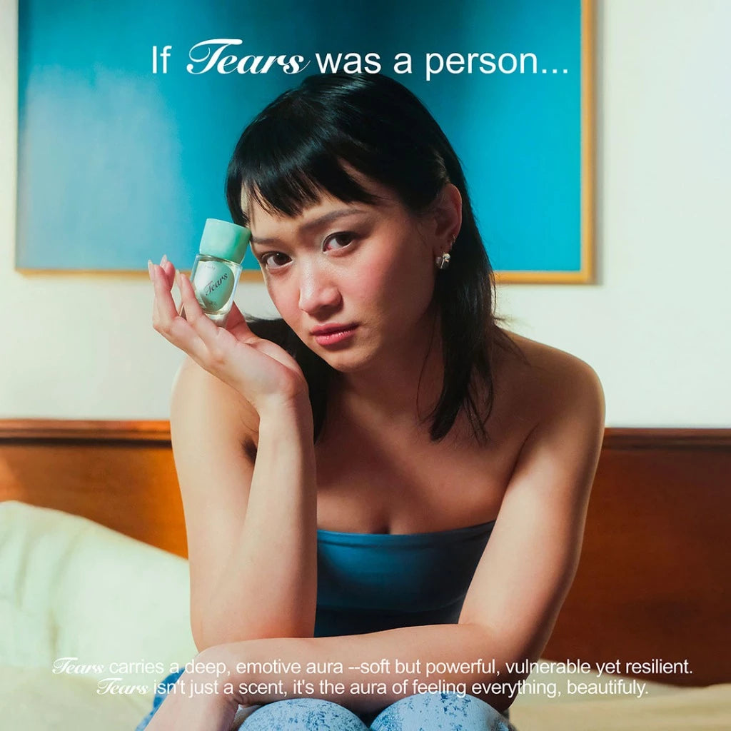 Woman holding a bottle of Tears Extrait De Parfum (30ml) from Kitschy