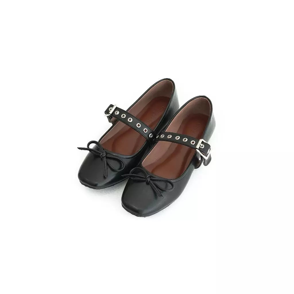 Black flatshoes with bow details and buckles by Tangerine Marche on a white background
