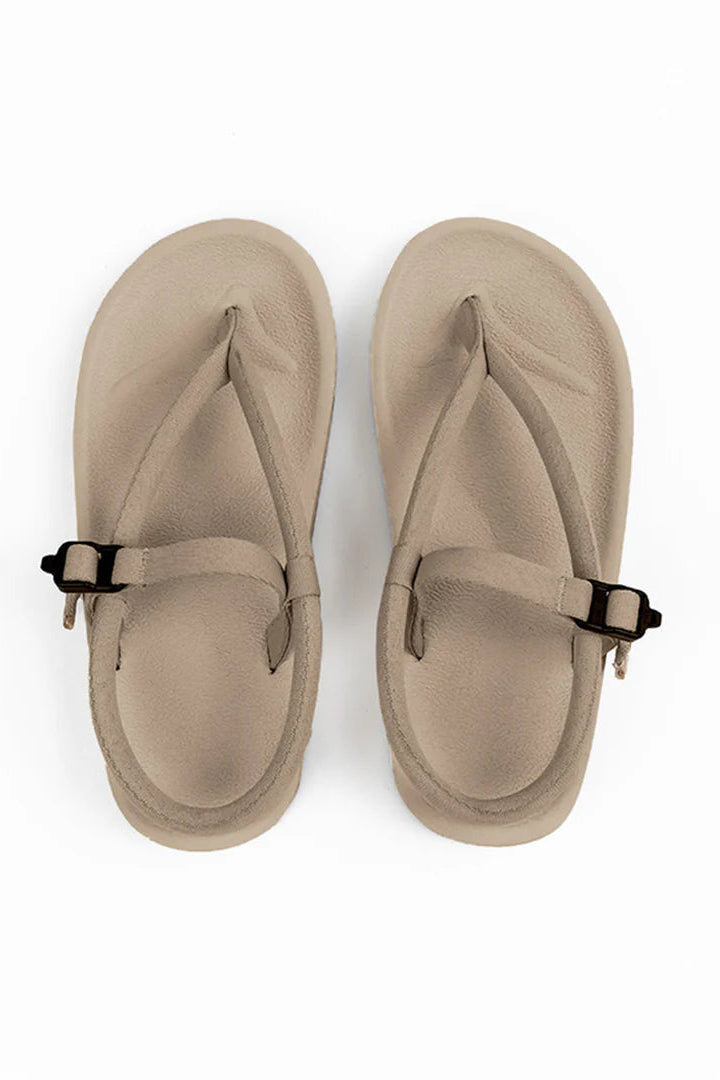 A pair of taupe-colored thong sandals by Gahalu with adjustable straps and black buckle closures, shown from a top-down view on a white background.