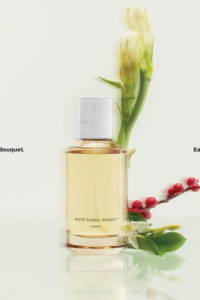 Bottle of 'White Floral Bouquet' Eau De Parfum by Scents of Pluto with floral elements on a light background