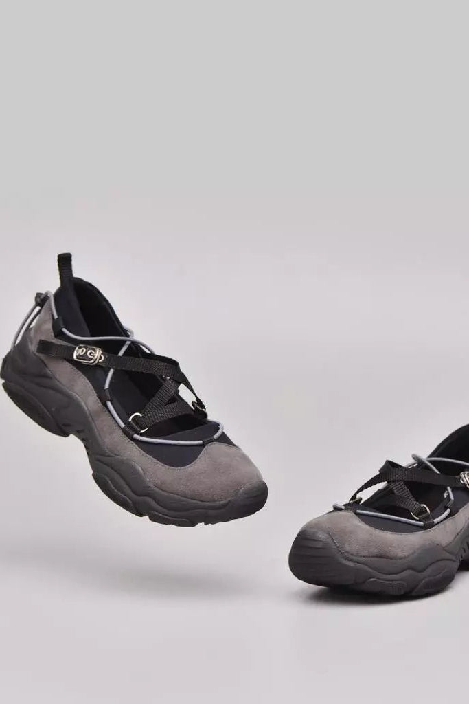 Pair of gray and black shoes by Adorable Projects on a light gray background