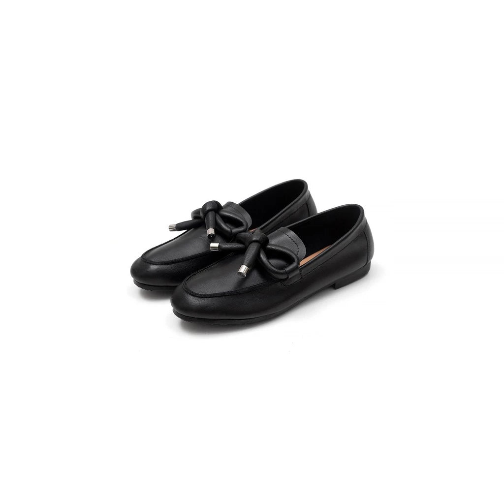 Black loafers flatshoes with a bow on a white background