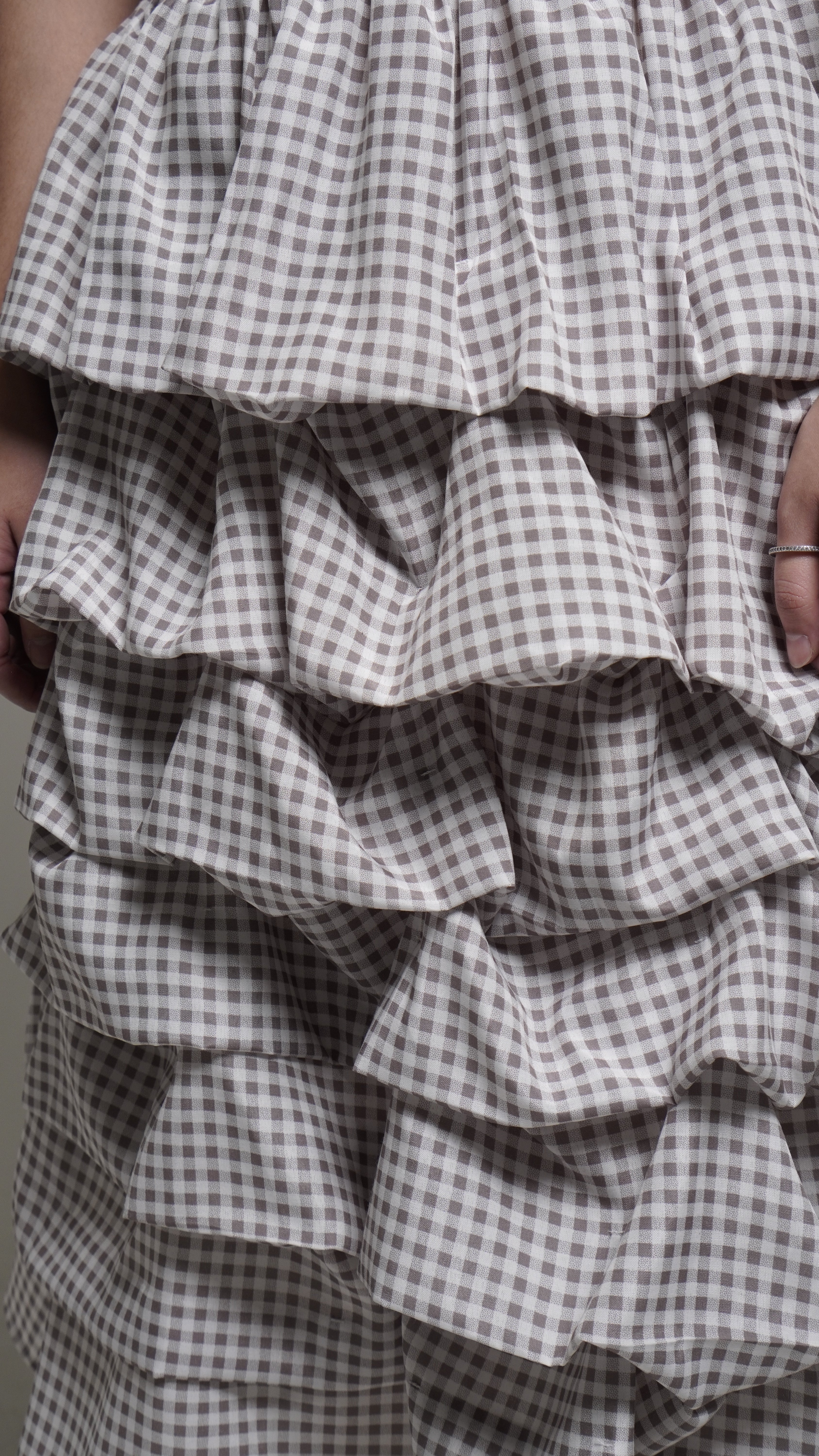 Close-up of a grey checkered skirt with a focus on texture and pattern.