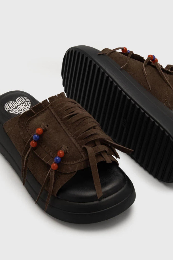 Brown sandals by Adorable Projects with black soles on a white background