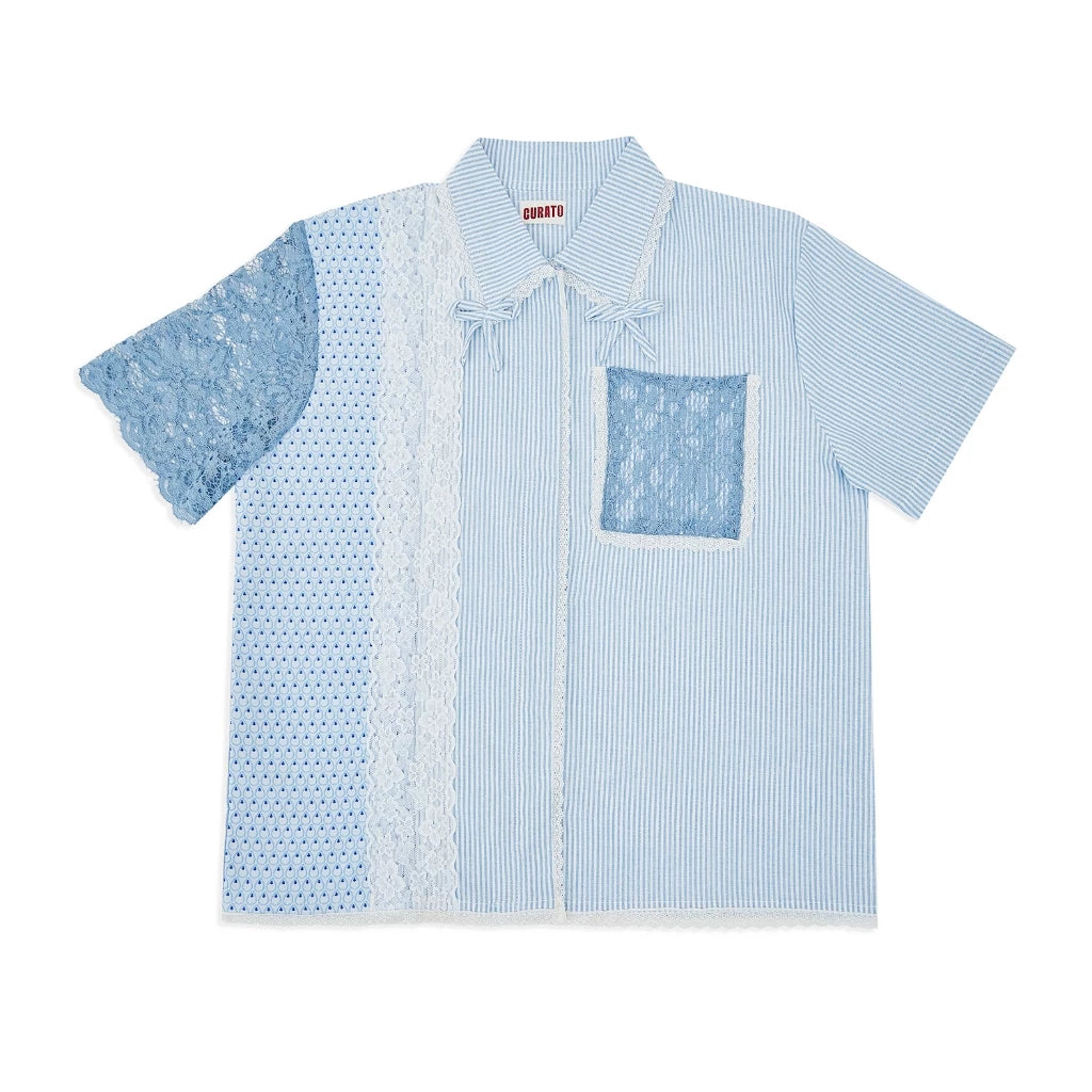 Blue patterned shirt with lace details on a white background