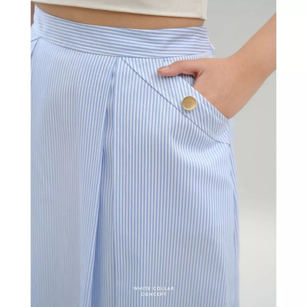 Light blue striped skirt with a gold button on a neutral background
