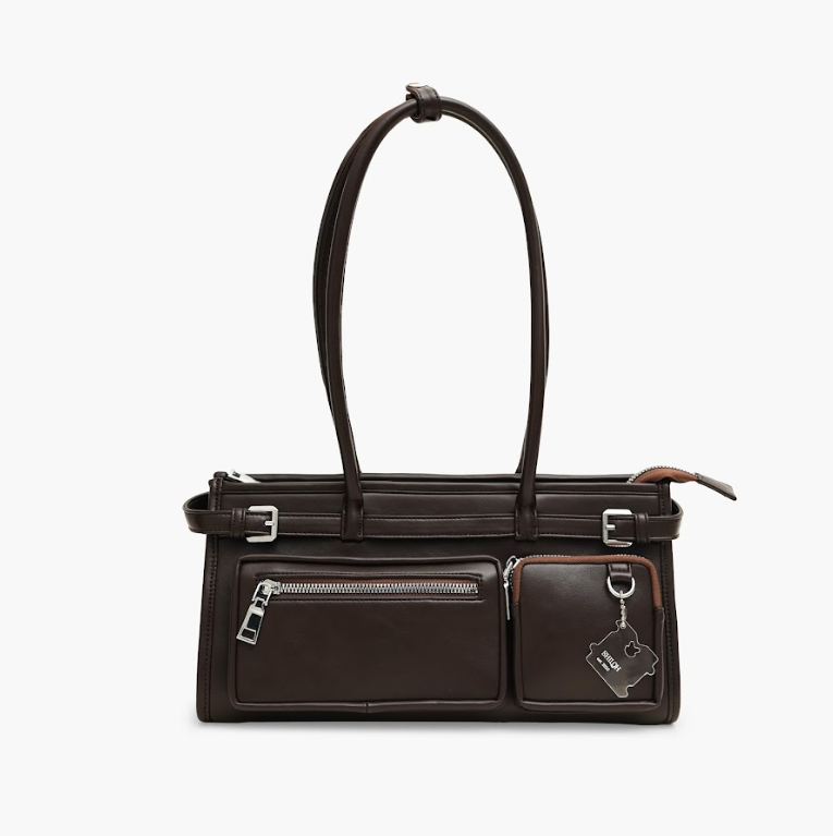 Brown leather handbag with multiple pockets and a shoulder strap on a white background

Tas tangan kulit wanita berwarna cokelat dengan banyak saku dan tali bahu pada latar belakang putih