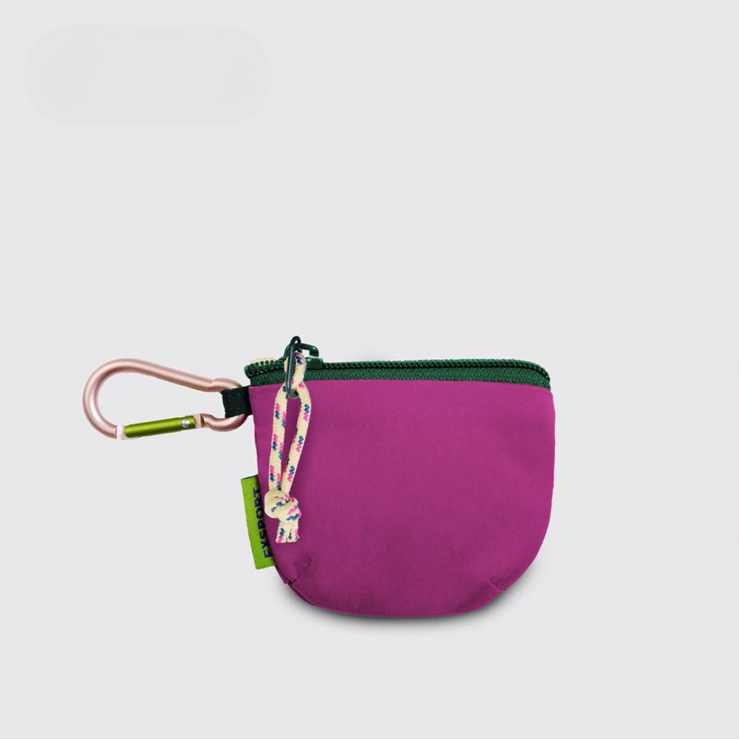 An Export Bags purple pouch with a green zipper and light purple carabiner on a light gray background