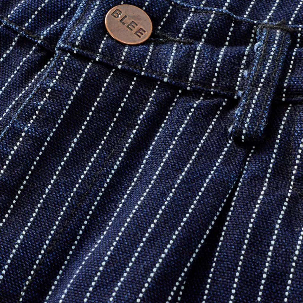 Close-up of a navy stripe pants with a 'BLEE' button.