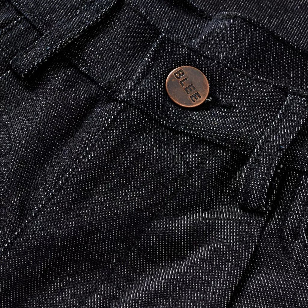 Close-up of black denim fabric with a 'BLEE' brand button.